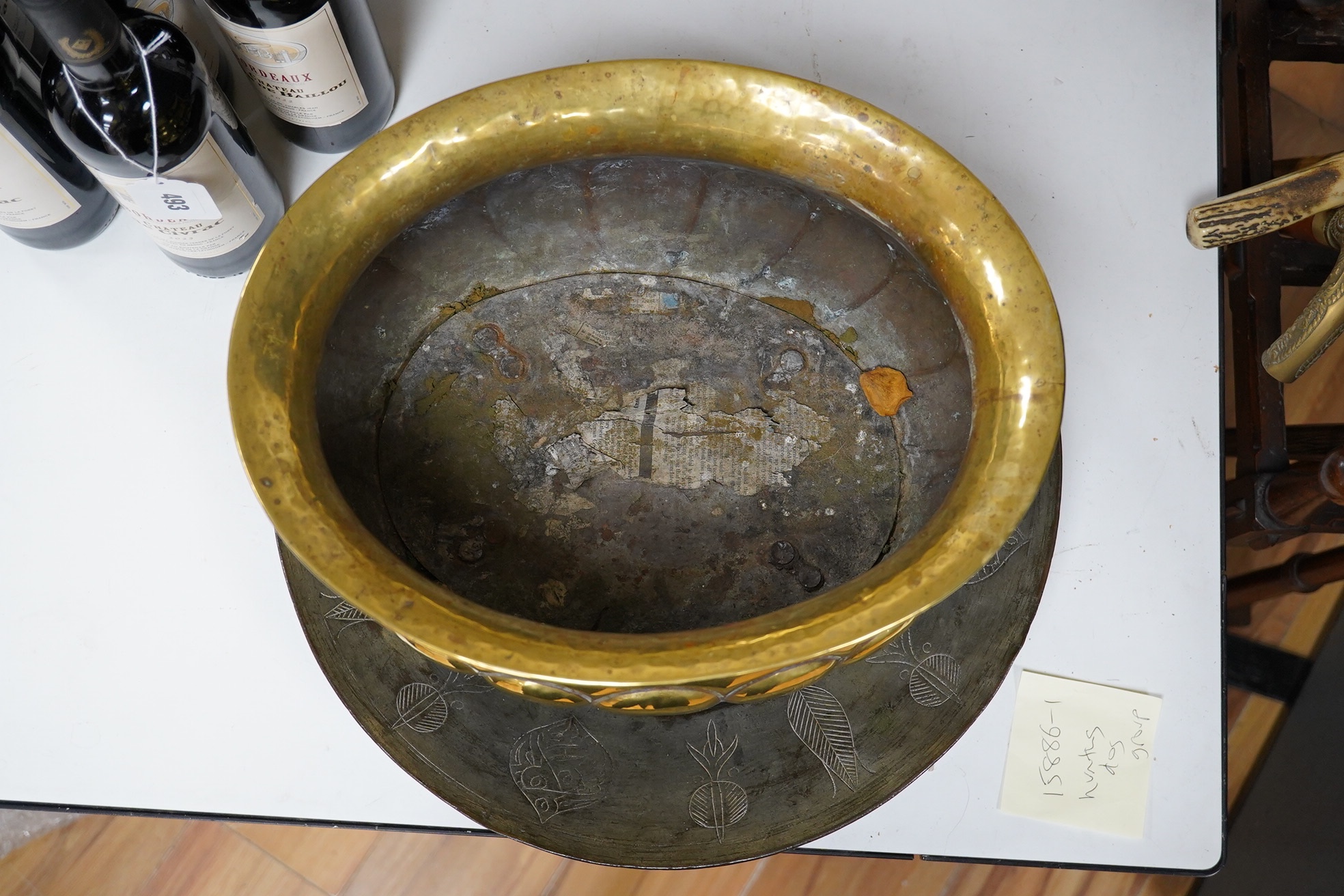A n18th century style Dutch embossed brass oval jardiniere and a circular metal engraved plaque, jardiniere approximately 40cm wide (2). Condition - plaque rusty at centre, jardiniere fair